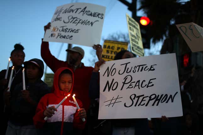 Black Lives Matter protesters hold candles during a vigil and demonstration on March 23, 2018 in Sacramento, California.