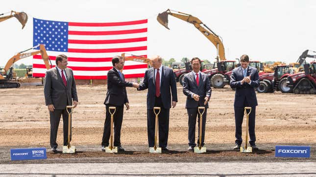 U.S. President Donald Trump (C) shakes hanks with Wisconsin Gov. Scott Walker at the groundbreaking of the Foxconn Technology Group computer screen plant on June 28, 2018 in Mt Pleasant, Wis.