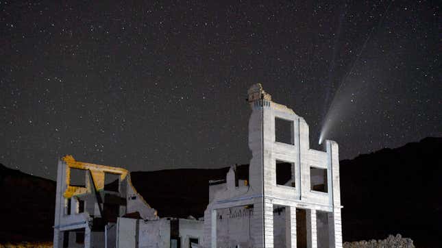 The Comet NEOWISE (C/2020 F3) is seen above the ruins of the Cook Bank building along with diagonal streaks caused by passing satellites in this 20-second camera exposure on July 20, 2020 in the ghost town of Rhyolite, Nevada. The comet is named after NASA’s Near-Earth Object Wide-field Infrared Survey Explorer, which discovered it in March. It is about three miles wide and 70 million miles from Earth while traveling at 144,000 mph as it moves away from the sun.