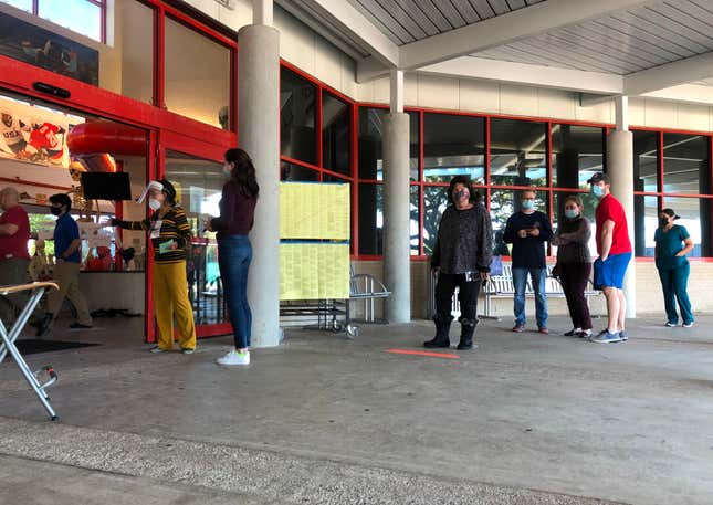 People wait in line to cast their ballots outside the Metropolitan Multi-Services Center of Montrose in Houston on the last day of early voting October 30, 2020.